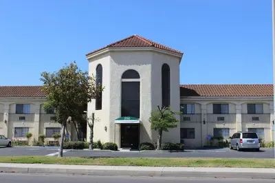 a building with a car parked in front of it at Ocean Gateway Inn in Santa Paula