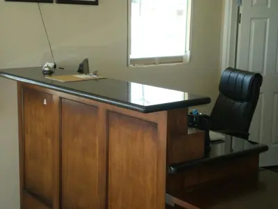 a desk with a black counter top and a chair at Executive Inn Mojave in Mojave