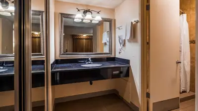 a bathroom with a sink and a mirror at SureStay Hotel by Best Western Tehachapi in Tehachapi