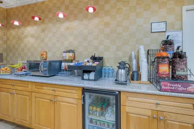 a kitchen with a counter with a refrigerator at SureStay Hotel by Best Western Camarillo in Camarillo