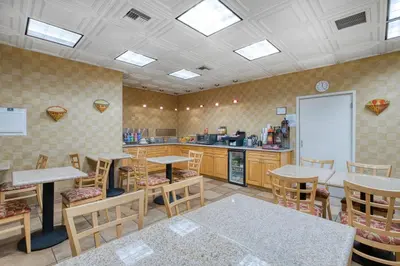 a room with tables and chairs and a kitchen at SureStay Hotel by Best Western Camarillo in Camarillo