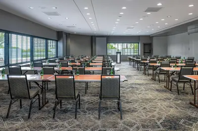 a conference room with tables and chairs and windows at Hilton Los Angeles-Universal City in Los Angeles