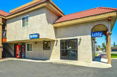 a store front of a building with a sign for loyalty at Americas Best Value Inn-Rialto in Rialto
