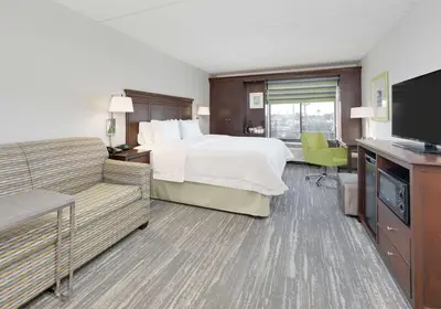 a hotel room with a bed and a television at Hampton Inn Los Angeles/Carson in Carson