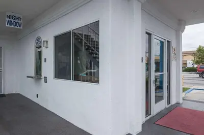 a white building with a window on the side of it at Motel 6-Norwalk, CA in Norwalk