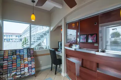 a restaurant with a counter and a chair in a room at Motel 6-Norwalk, CA in Norwalk