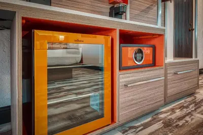 a glass door in a room with a tv at Casa Via Mar Inn, an Ascend Collection Hotel in Port Hueneme