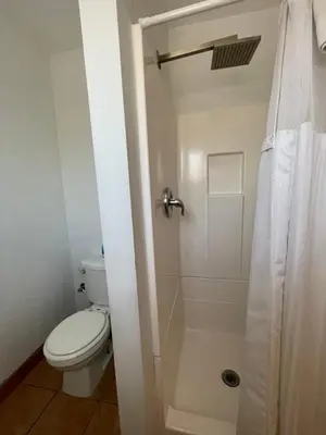 a bathroom with a toilet and a shower at Howard Johnson by Wyndham Ridgecrest, CA in Ridgecrest