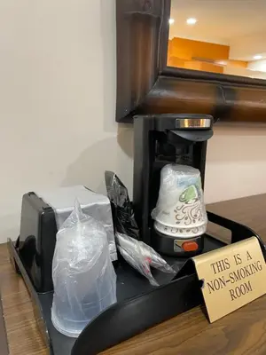 a coffee maker with a sign that says this is a non smoking room at Howard Johnson by Wyndham Ridgecrest, CA in Ridgecrest