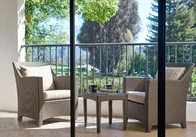 two chairs and a table on a balcony at Ojai Valley Inn in Ojai