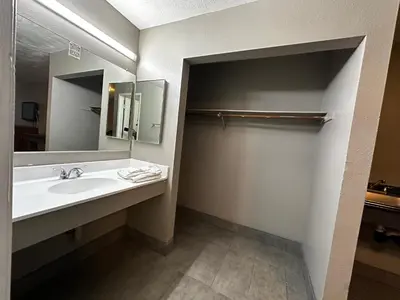 a bathroom with a sink and a mirror at Sunpark Inn & Suites in San Bernardino