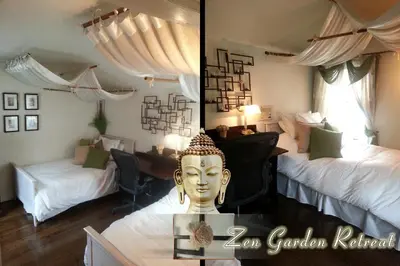 a room with two beds and a statue of a head at The Patrician Hollywood Universal in Pasadena