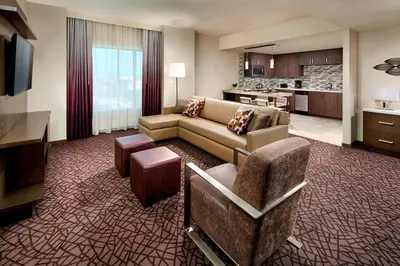 a living room with a couch and chairs and a kitchen at Residence Inn by Marriott at Anaheim Resort/Convention Center in Anaheim