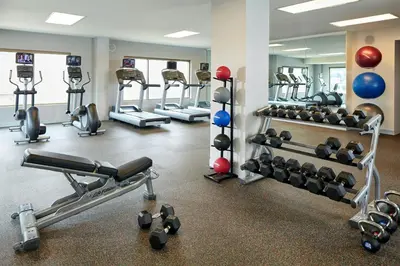 a gym with several tread machines and weights at Residence Inn by Marriott at Anaheim Resort/Convention Center in Anaheim