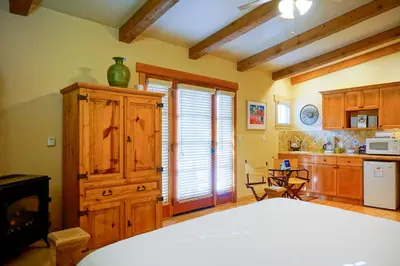 a kitchen with a large white bed in a room at Blue Iguana Inn in Ojai
