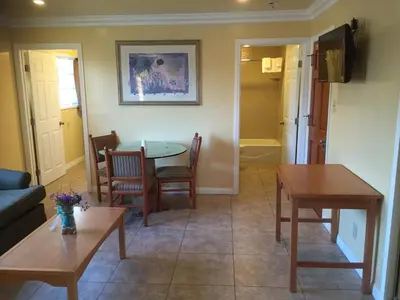 a living room with a table and chairs at Bayshore Inn Ventura in Ventura