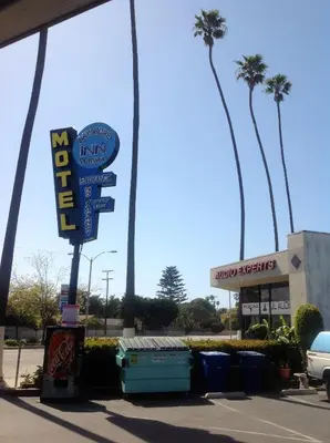 a sign for a fast food restaurant in a parking lot at Bayshore Inn Ventura in Ventura