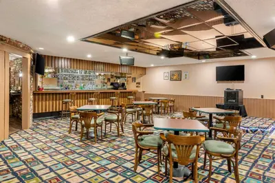 a restaurant with tables and chairs and a bar at Clarion Hotel Anaheim Resort in Anaheim