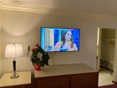 a flat screen tv on a wall in a room at Best Inn Rosemead in Rosemead