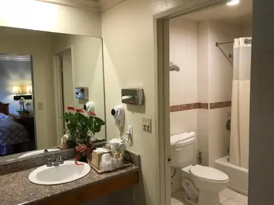 a bathroom with a sink and a toilet and a mirror at Best Inn Rosemead in Rosemead