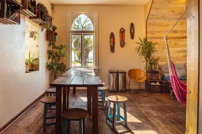 a room with a table and chairs and a window at Samesun Venice Beach Hotel & Hostel in Los Angeles