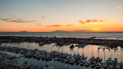 a group of boats docked in a marina at sunset at Hampton Inn Channel Islands Harbor in Oxnard