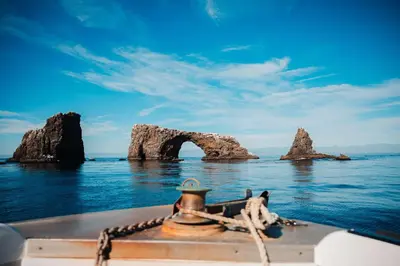 a boat in the water with rocks in the water at Hampton Inn Channel Islands Harbor in Oxnard