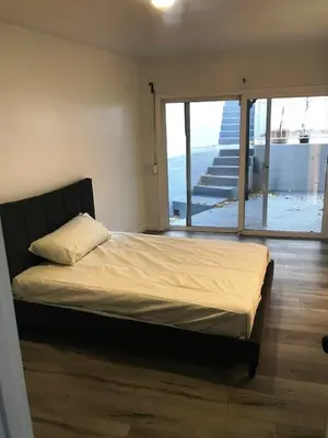 a bedroom with a bed in a room with a balcony at 4 bedroom and 3 bath home close to universal studio and Hollywood in Sherman Oaks