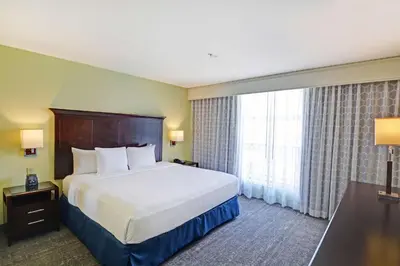 a hotel room with a bed and a large window at Embassy Suites Valencia in Valencia
