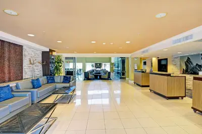 a large lobby with couches and a table in it at Embassy Suites Valencia in Valencia
