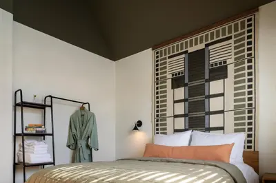 a bedroom with a bed and a large window at Hotel Marina Riviera in Big Bear Lake