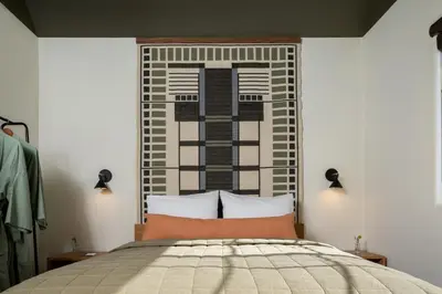 a bedroom with a bed with a large headboard at Hotel Marina Riviera in Big Bear Lake