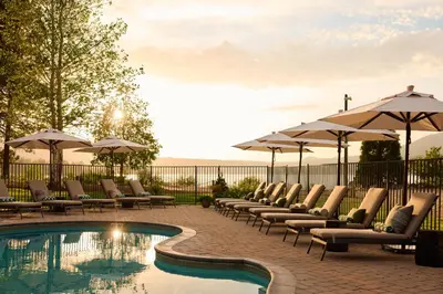 a row of chairs and umbrellas next to a pool at Hotel Marina Riviera in Big Bear Lake