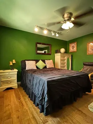 a bedroom with green walls and a large bed at Beautiful Foothill Home in Rancho Cucamonga