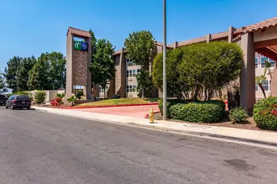 a yellow fire hydrant on a sidewalk in front of a building at Holiday Inn Express & Suites Camarillo by IHG in Camarillo