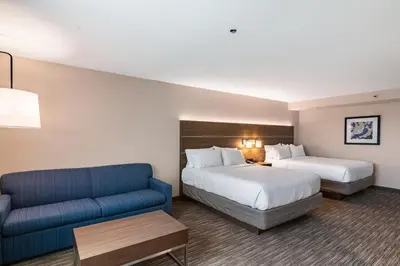 a hotel room with two beds and a couch at Holiday Inn Express & Suites Camarillo by IHG in Camarillo