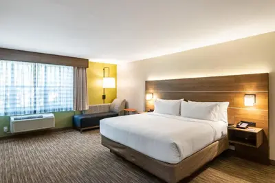 a hotel room with a bed and a chair at Holiday Inn Express & Suites Camarillo by IHG in Camarillo