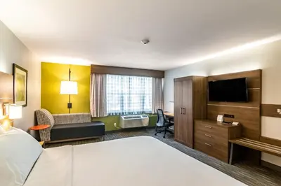 a hotel room with a bed and a flat screen tv at Holiday Inn Express & Suites Camarillo by IHG in Camarillo
