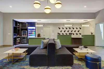 a large living room with a couch and tables at Doubletree By Hilton Palmdale, Ca in Palmdale