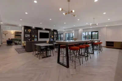 a kitchen and living room with a table and chairs at Doubletree By Hilton Palmdale, Ca in Palmdale