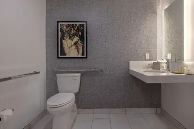a bathroom with a toilet and a sink at Doubletree By Hilton Palmdale, Ca in Palmdale