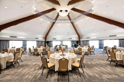 a banquet room with tables and chairs and a ceiling at Four Points by Sheraton Ventura Harbor Resort in Ventura