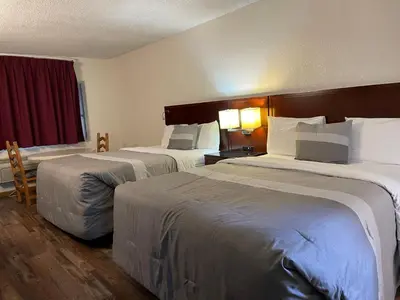 a hotel room with two beds and a window at Travelers Beach Inn in Ventura