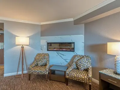 two chairs and a table in a hotel room at Amanzi Hotel, an Ascend Collection Hotel in Ventura