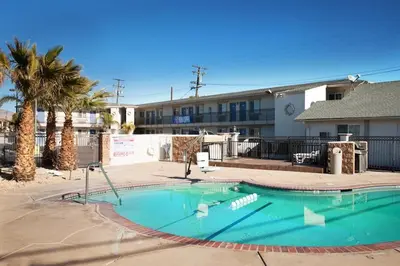 a large swimming pool in front of a building at Studio 6 Mojave, CA - Airport in Mojave