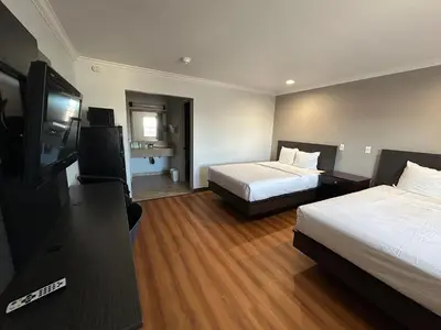 a hotel room with two beds and a flat screen tv at Studio 6 Mojave, CA - Airport in Mojave