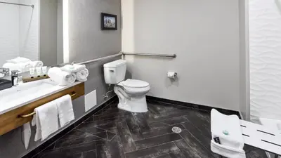 a bathroom with a toilet and a sink at Hollywood Inn Suites Hotel in Los Angeles