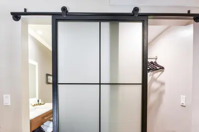 a sliding glass door with a black frame in a bathroom at Hollywood Inn Suites Hotel in Los Angeles