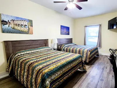 a bedroom with two beds and a ceiling fan at Santa Paula Inn in Santa Paula