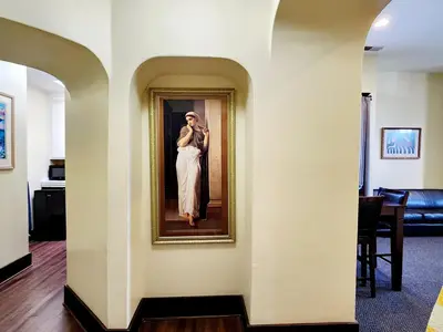 a picture of a woman in a painting on a wall at Santa Paula Inn in Santa Paula